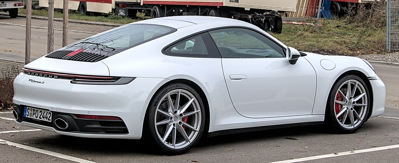White Porsche 911 Carrera S 992 Coupe, rear three-quarter view