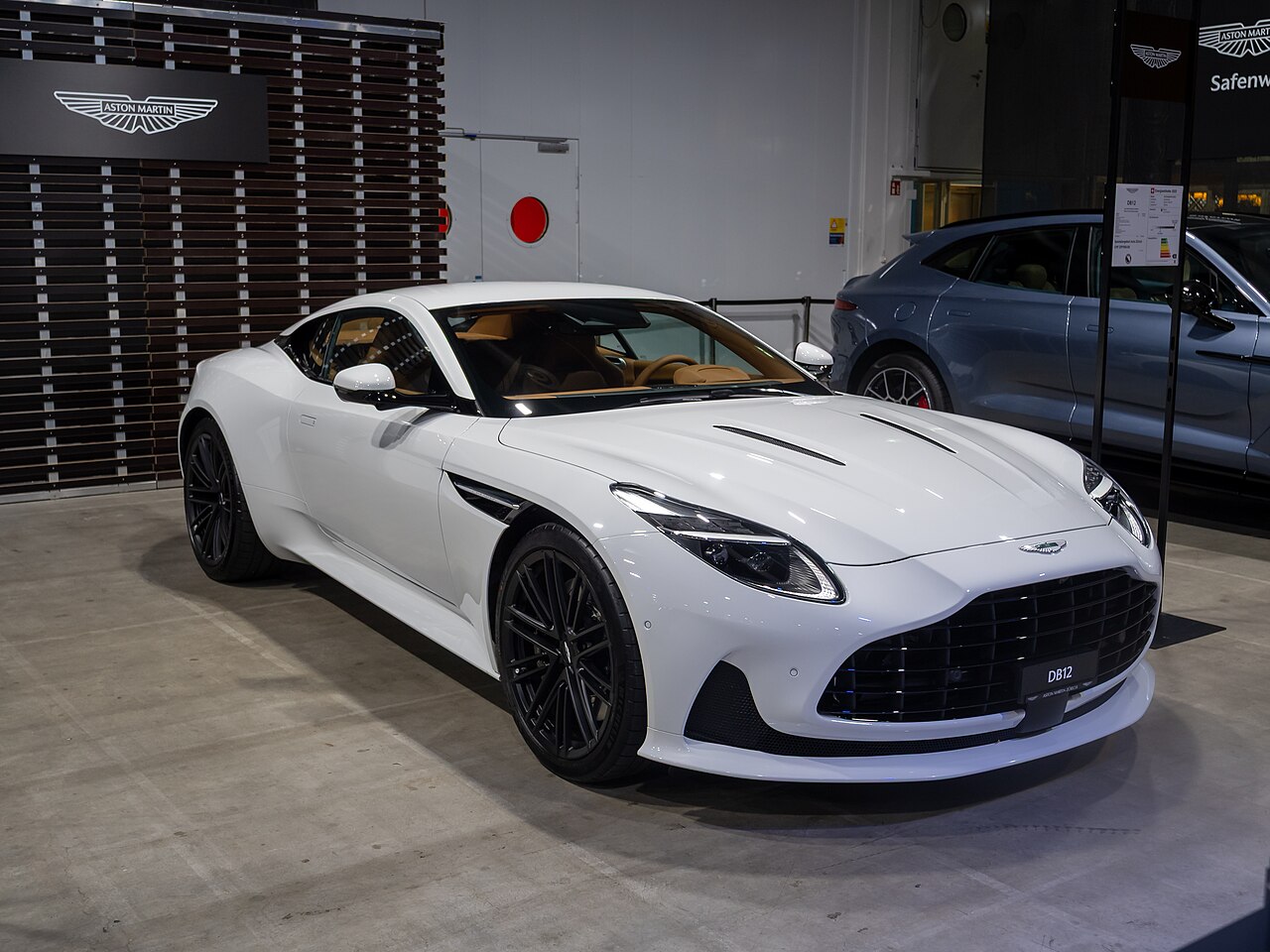 White Aston Martin DB12 Coupe in a showroom