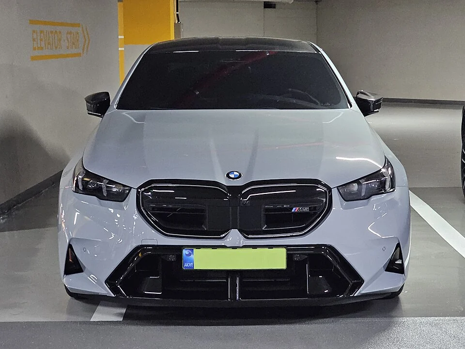 Front exterior — BMW M5 G90 front exterior; the second photograph is another front angle, not a rear view.