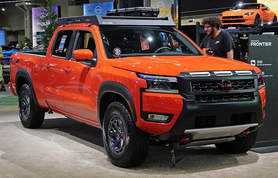 Front exterior — 2025 Nissan Frontier PRO-4X at the New York auto show; off-road trim equipment is not standard on every Frontier.
