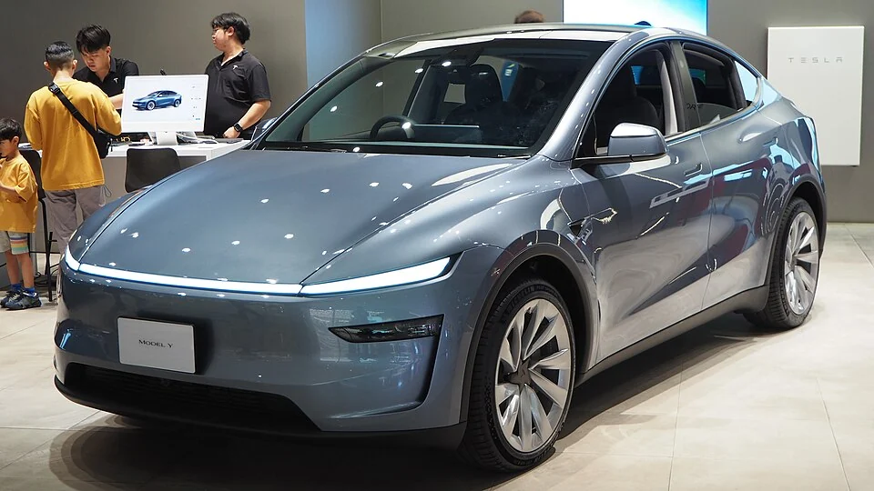 Front exterior — Refreshed 2025 Tesla Model Y Long Range AWD shown in Thailand; right-hand-drive interior and overseas equipment, not a U.S. configuration guarantee.