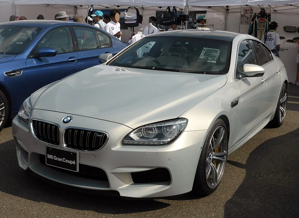 Front exterior — BMW M6 Gran Coupe F06 exterior and Japanese right-hand-drive interior reference; cabin configuration is market-specific.