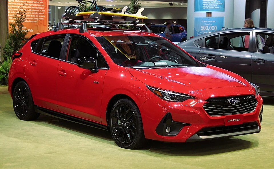 Front exterior — 2024 Subaru Impreza displayed at the 2023 New York auto show; the roof carrier is display equipment, not a standard feature on every trim.